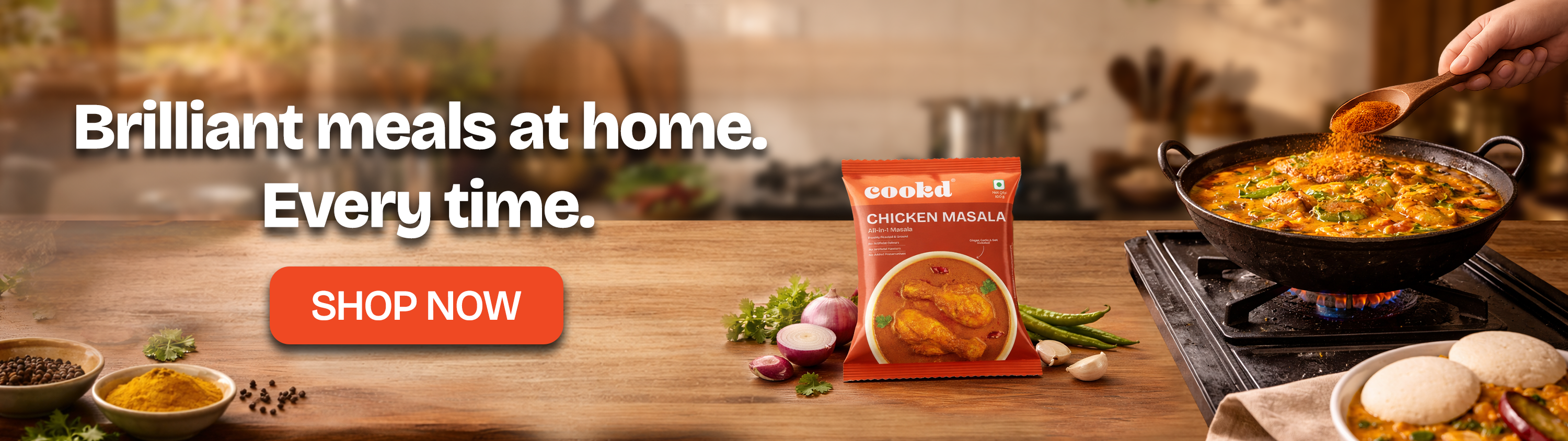 Cooked meal kit packaging with cooking pan and ingredients on a wooden table, promotional text 'Brilliant meals at home. Every time.