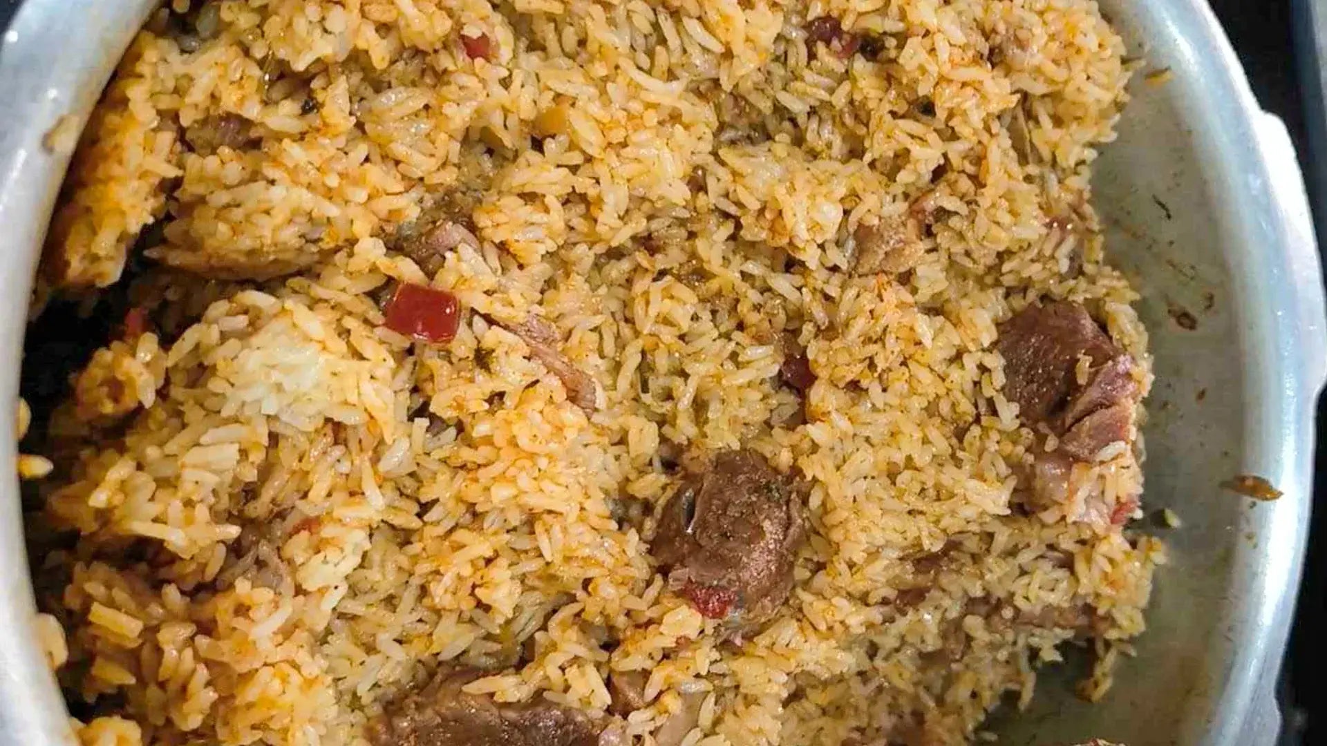 Close-up of a dish with rice and meat in a white bowl