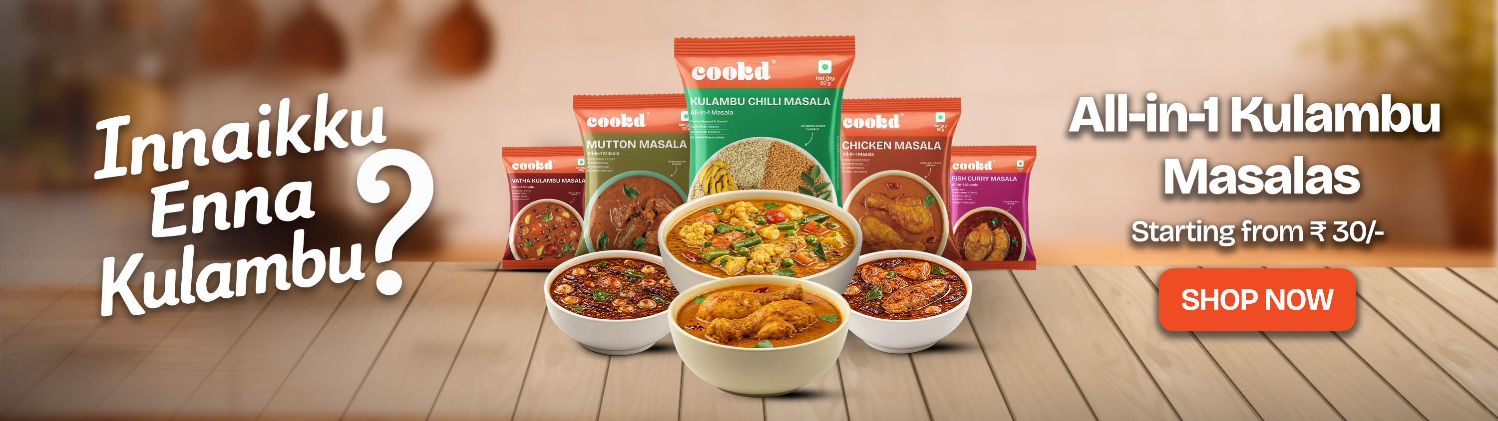 Promotional banner for All-in-One Kulambu Masalas with bowls of food and packaging on a wooden surface.